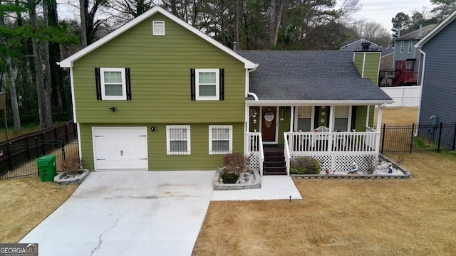 tri-level home with fence, a porch, concrete driveway, and roof with shingles