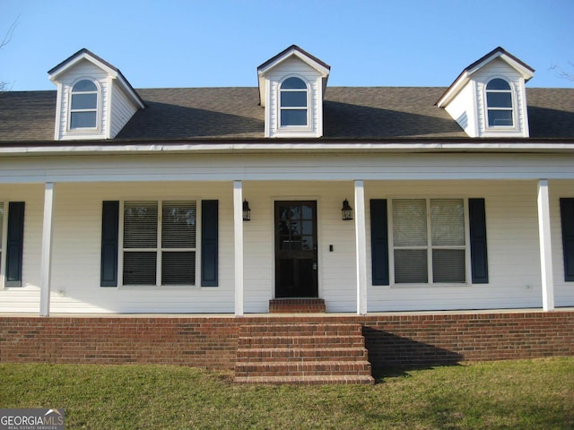 view of front of property featuring a porch and roof with shingles