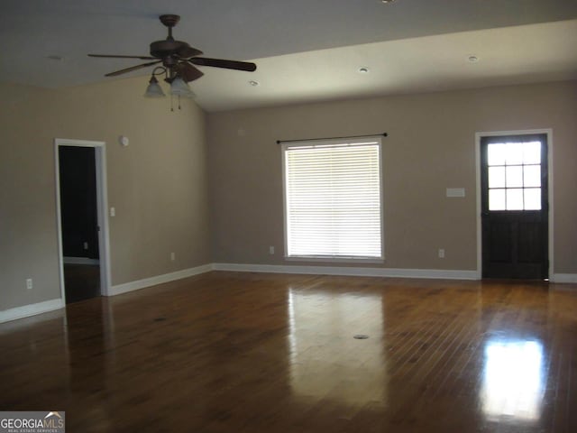 unfurnished living room featuring lofted ceiling, wood finished floors, a ceiling fan, and baseboards