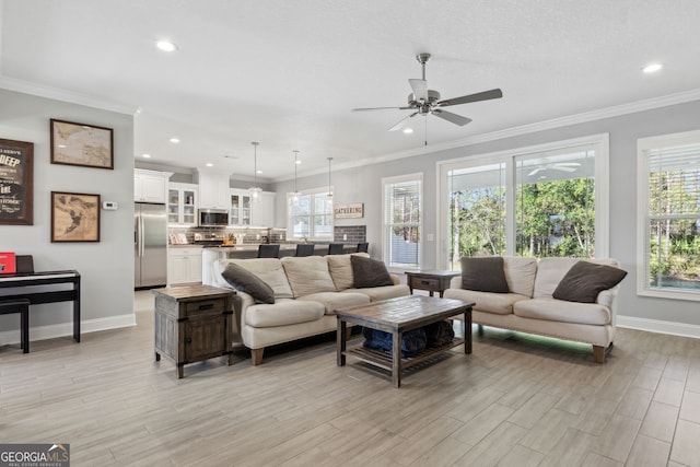 living area featuring light wood finished floors, baseboards, and ornamental molding