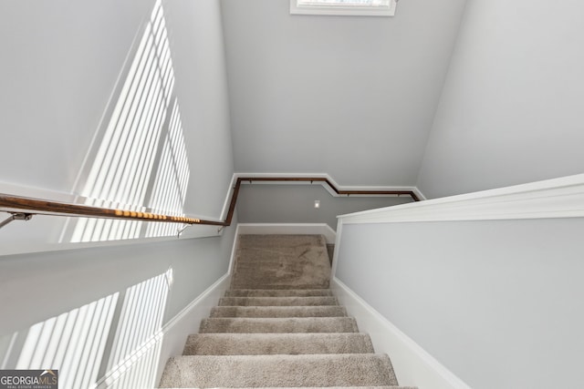 stairway with carpet and baseboards