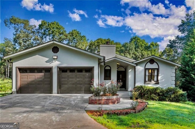 single story home featuring a garage, a chimney, concrete driveway, and stucco siding