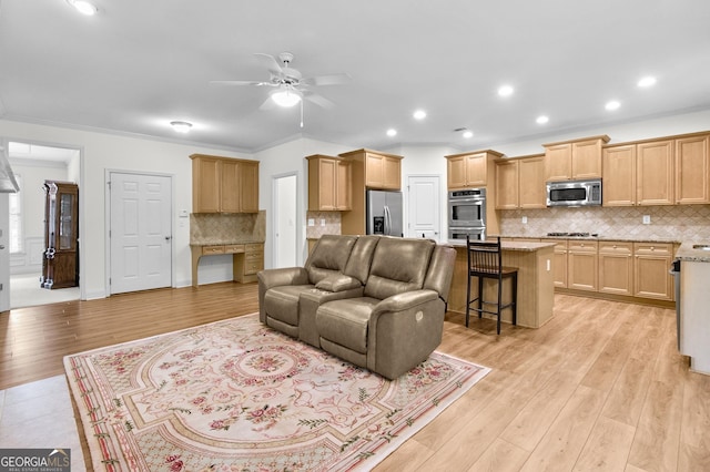 living room featuring light wood-style flooring, ceiling fan, crown molding, and recessed lighting