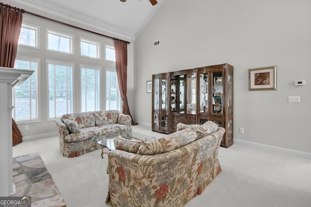 carpeted living room featuring high vaulted ceiling, visible vents, a ceiling fan, baseboards, and crown molding