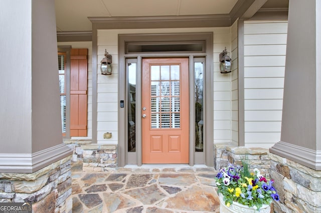 entrance to property with stone siding and covered porch