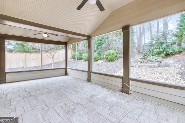 unfurnished sunroom with vaulted ceiling and a ceiling fan