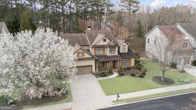 view of front of property with a garage, concrete driveway, and a front yard