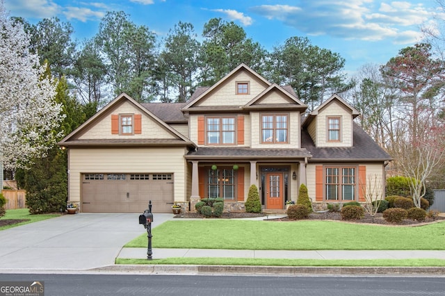 craftsman inspired home with a shingled roof, concrete driveway, stone siding, an attached garage, and a front yard