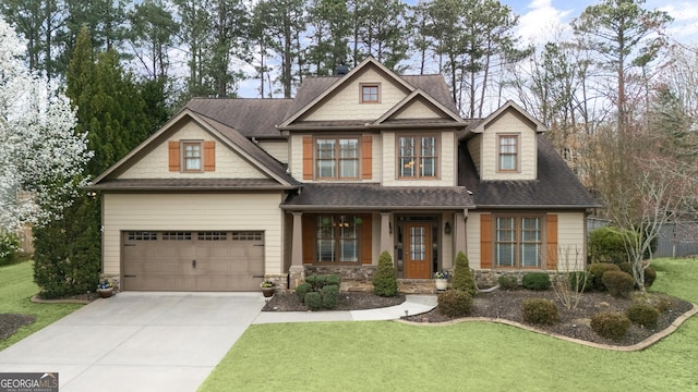 craftsman-style home featuring a front yard, stone siding, an attached garage, and concrete driveway