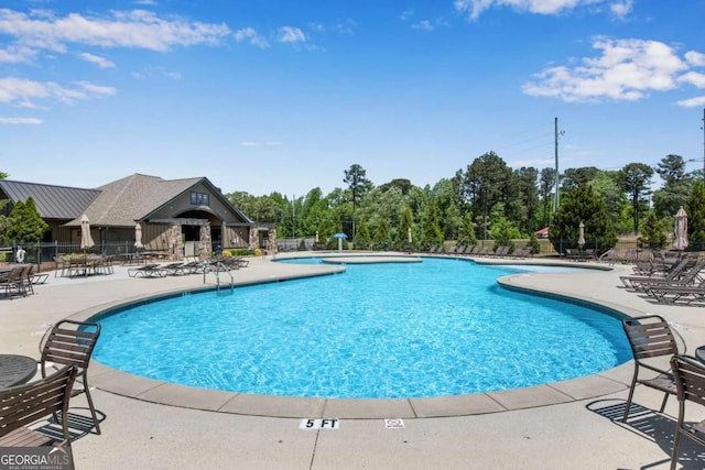 pool featuring a patio area and fence