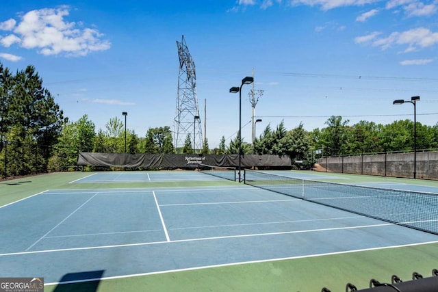 view of tennis court with fence