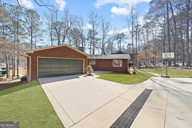 exterior space with driveway, an attached garage, and a front yard