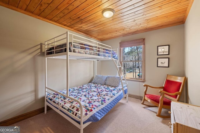 bedroom with crown molding, carpet, wood ceiling, and baseboards