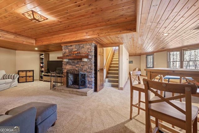 living area with wood ceiling, stairs, a stone fireplace, carpet floors, and recessed lighting