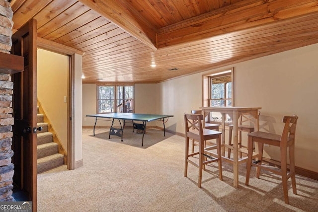 game room with carpet, wood ceiling, and baseboards