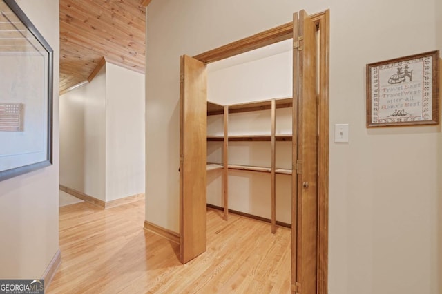 hallway with light wood-style flooring and baseboards