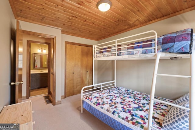 bedroom featuring carpet floors, wooden ceiling, and a closet