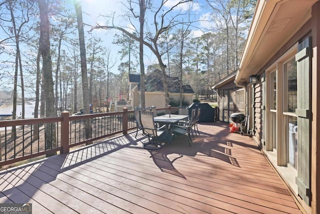 wooden deck featuring outdoor dining area