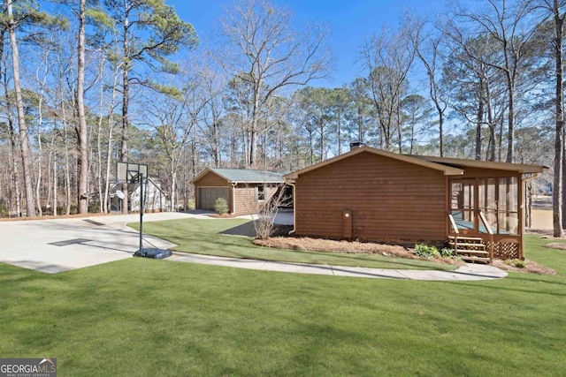 view of property exterior with a garage and a lawn