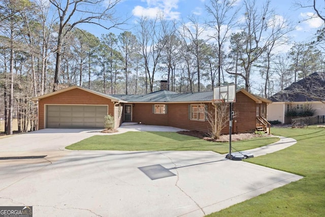 view of front facade with a garage, a chimney, a front lawn, and concrete driveway