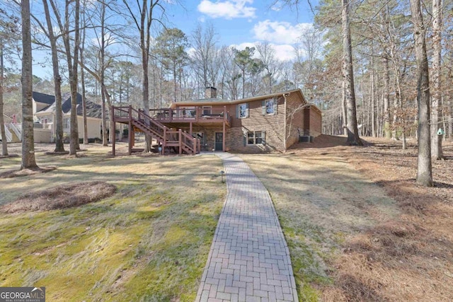 view of front of property featuring stone siding, stairs, a chimney, and a wooden deck