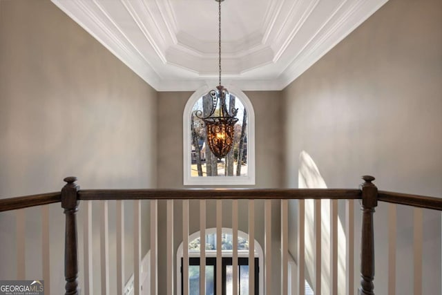 room details featuring crown molding, a tray ceiling, and an inviting chandelier