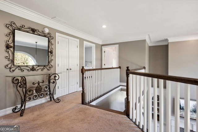 corridor with recessed lighting, carpet flooring, an upstairs landing, baseboards, and crown molding