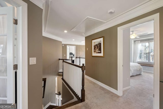 hallway featuring baseboards, carpet floors, an upstairs landing, and attic access