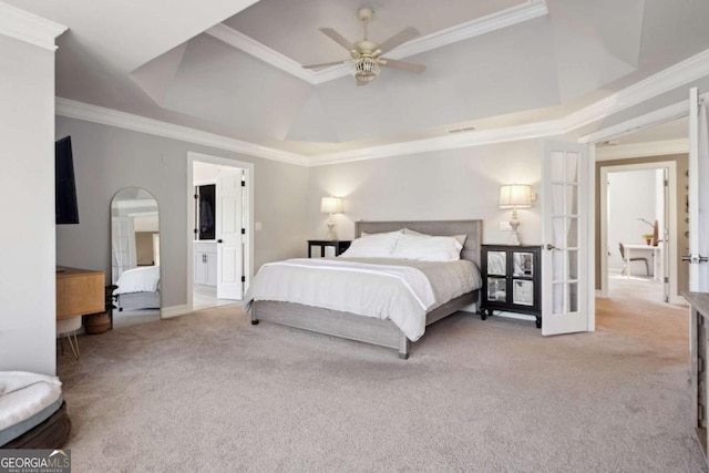 bedroom with carpet floors, a raised ceiling, visible vents, and crown molding