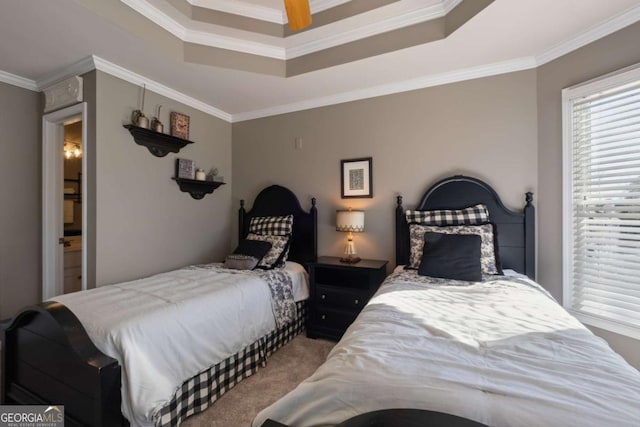 carpeted bedroom featuring ornamental molding and a raised ceiling