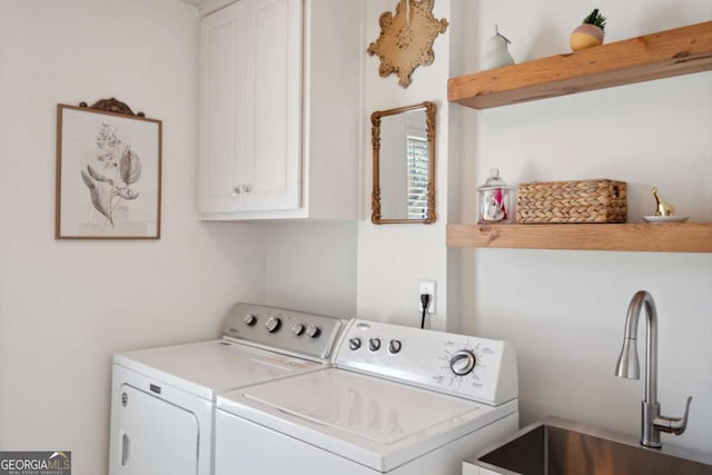 laundry room featuring washer and dryer, cabinet space, and a sink