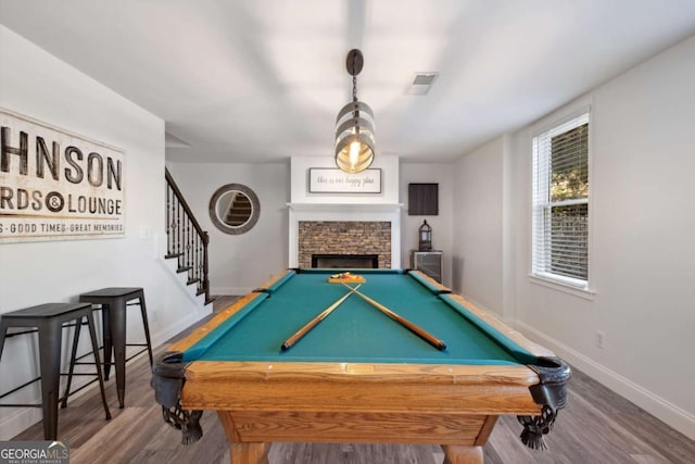 rec room featuring billiards, a fireplace, baseboards, and wood finished floors