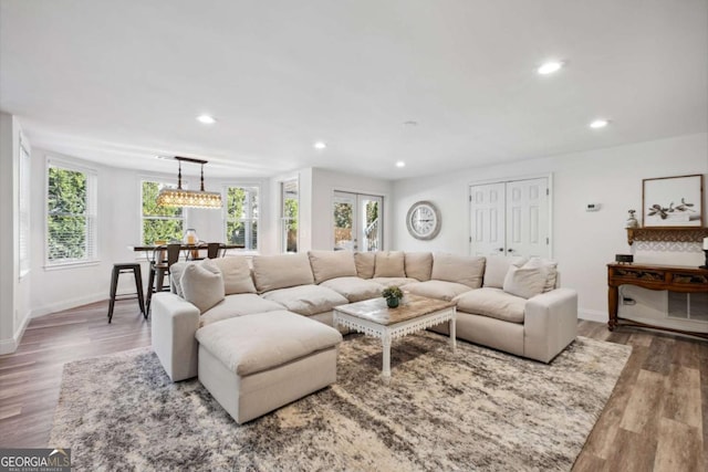 living room featuring baseboards, french doors, wood finished floors, and recessed lighting