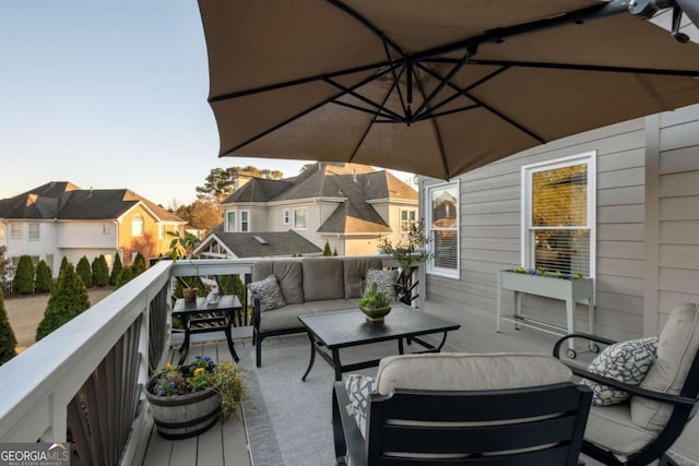 wooden terrace with a residential view and an outdoor hangout area