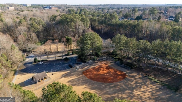 bird's eye view with a wooded view