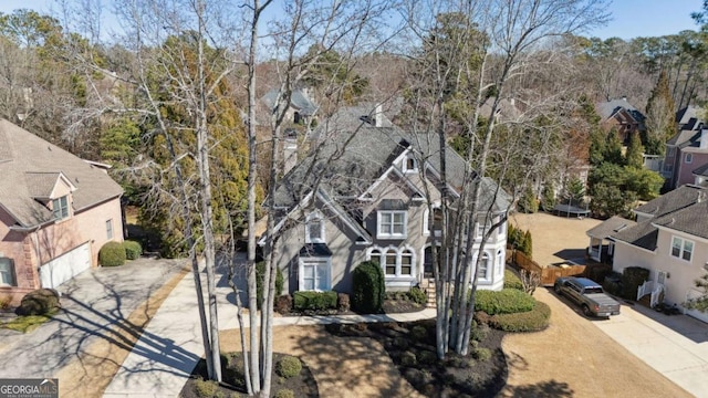 view of front of property with a garage, concrete driveway, and a residential view