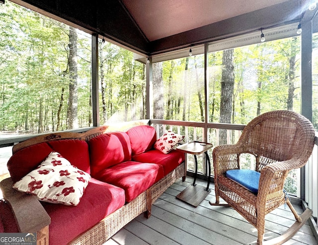 sunroom / solarium featuring vaulted ceiling