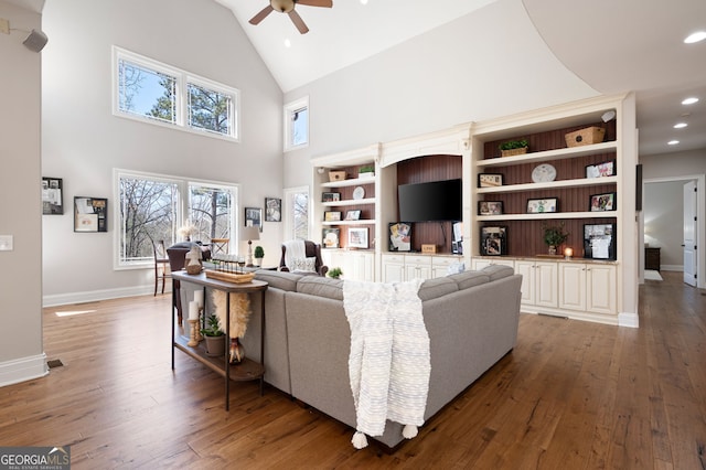 living area with recessed lighting, ceiling fan, high vaulted ceiling, baseboards, and hardwood / wood-style flooring