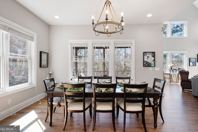 dining room featuring an inviting chandelier, baseboards, wood finished floors, and recessed lighting