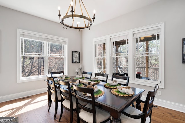 dining space featuring a healthy amount of sunlight, baseboards, and wood finished floors