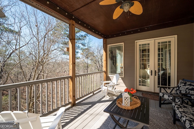 wooden terrace with ceiling fan and french doors