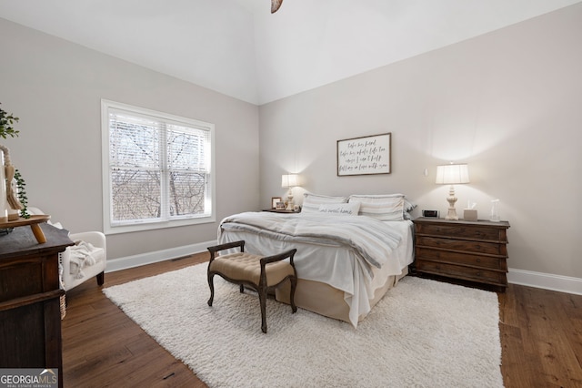 bedroom featuring wood finished floors, visible vents, and baseboards