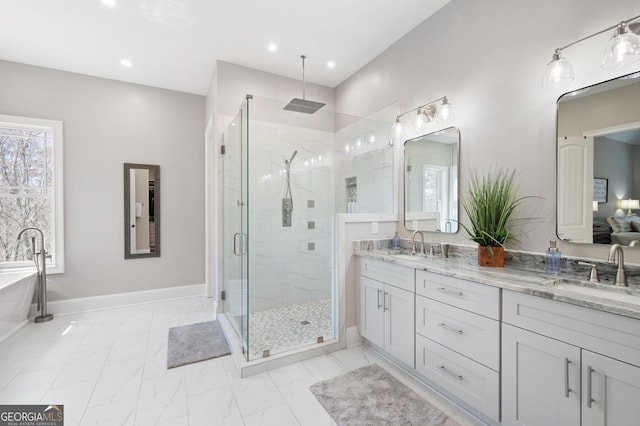 bathroom with baseboards, marble finish floor, a sink, and a shower stall