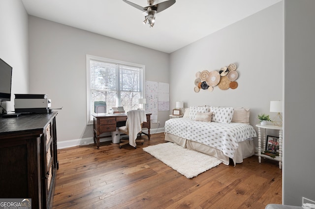 bedroom featuring hardwood / wood-style flooring and baseboards