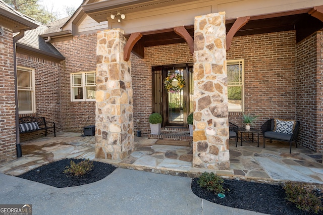 property entrance featuring stone siding and brick siding