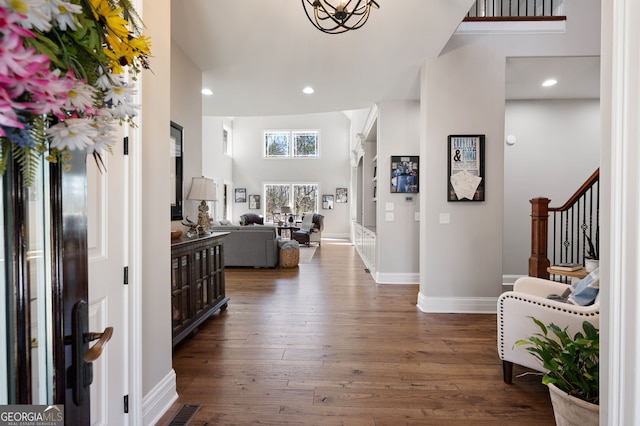 entryway with visible vents, baseboards, dark wood-style floors, stairway, and recessed lighting