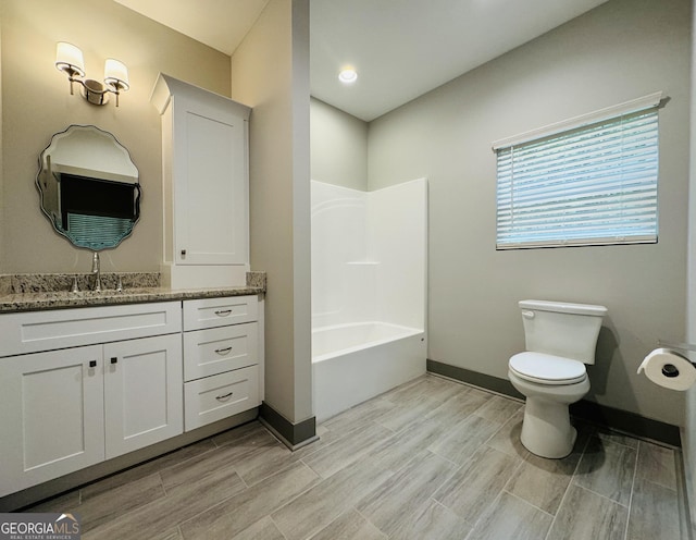 full bathroom with wood tiled floor, baseboards, vanity, and toilet