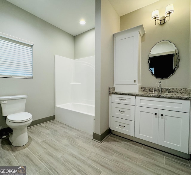 full bathroom featuring toilet, wood tiled floor, baseboards, and vanity