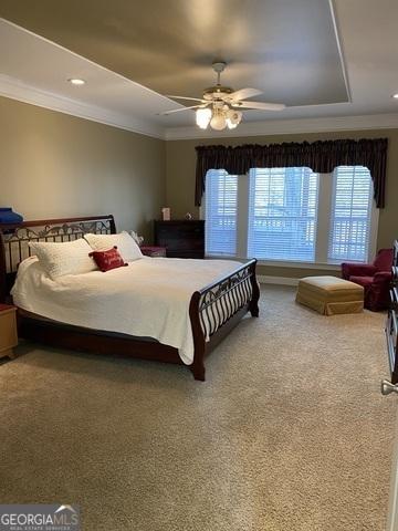 carpeted bedroom with ornamental molding, a tray ceiling, recessed lighting, and a ceiling fan