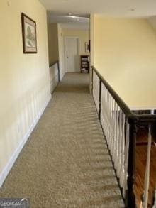 corridor with carpet floors and baseboards